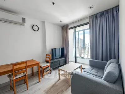 Modern living room with balcony view, featuring sleek furniture and ample natural light.