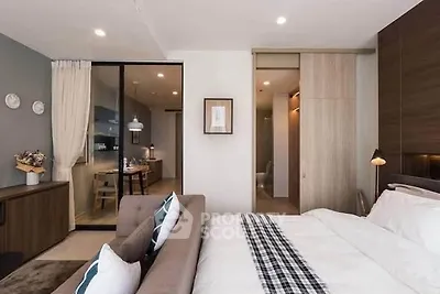 Modern bedroom with stylish decor and open layout to dining area
