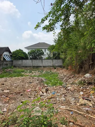 Vacant land with potential for development, surrounded by residential homes and greenery.