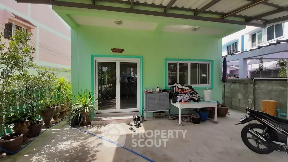 Charming single-story home with patio and lush potted plants