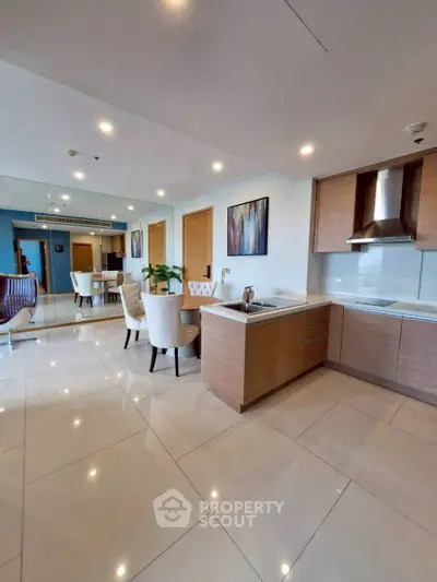 Spacious modern kitchen with dining area and sleek cabinetry in a luxury apartment.