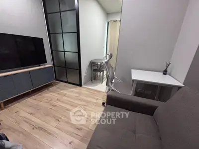 Modern living room with sleek furniture and wooden flooring