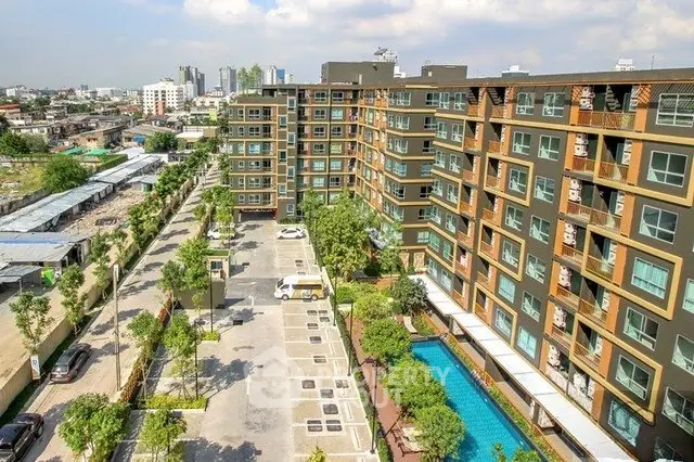 Modern apartment complex with pool and parking in urban setting