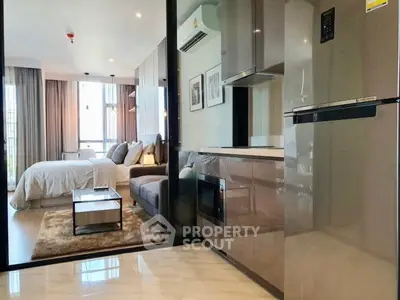 Modern studio apartment with sleek kitchen and cozy living area