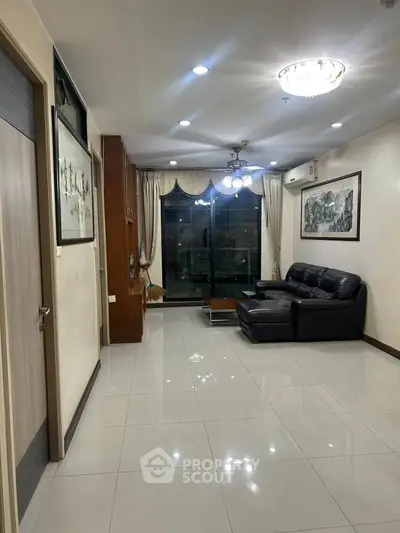 Spacious living room with modern decor and large windows offering natural light.