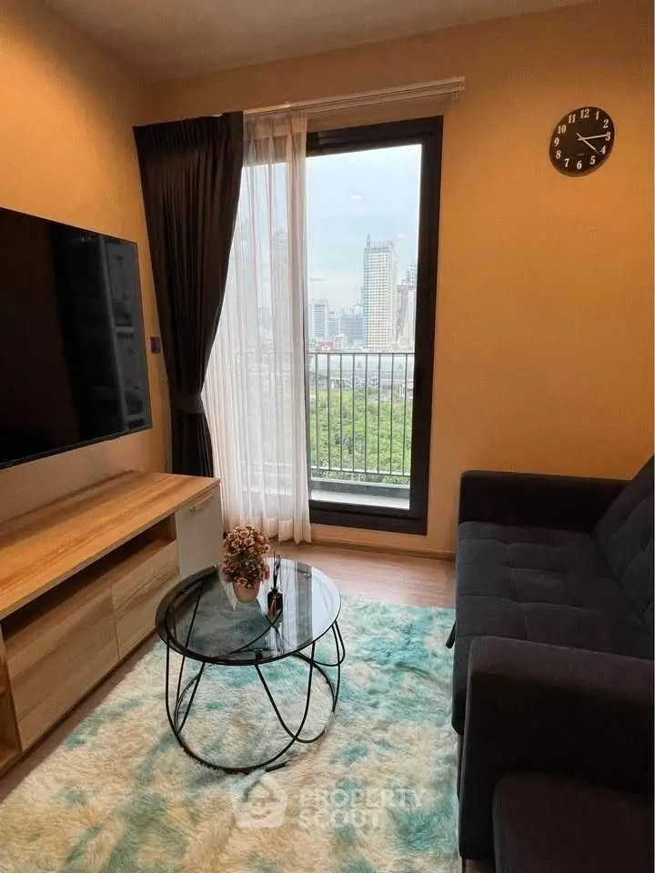 Cozy living room with city view, modern decor, and large TV, perfect for urban living.