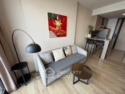 Modern living room with stylish decor and open kitchen layout in a contemporary apartment.