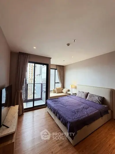 Spacious bedroom with large window and city view, featuring a comfortable bed and modern decor.