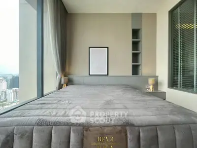 Luxurious bedroom with panoramic city view and modern decor in high-rise apartment.