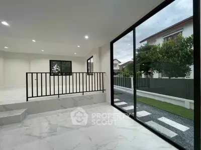 Spacious modern living room with large windows and garden view