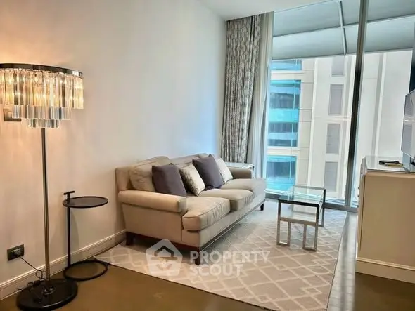 Modern living room with elegant decor and large windows offering city views.