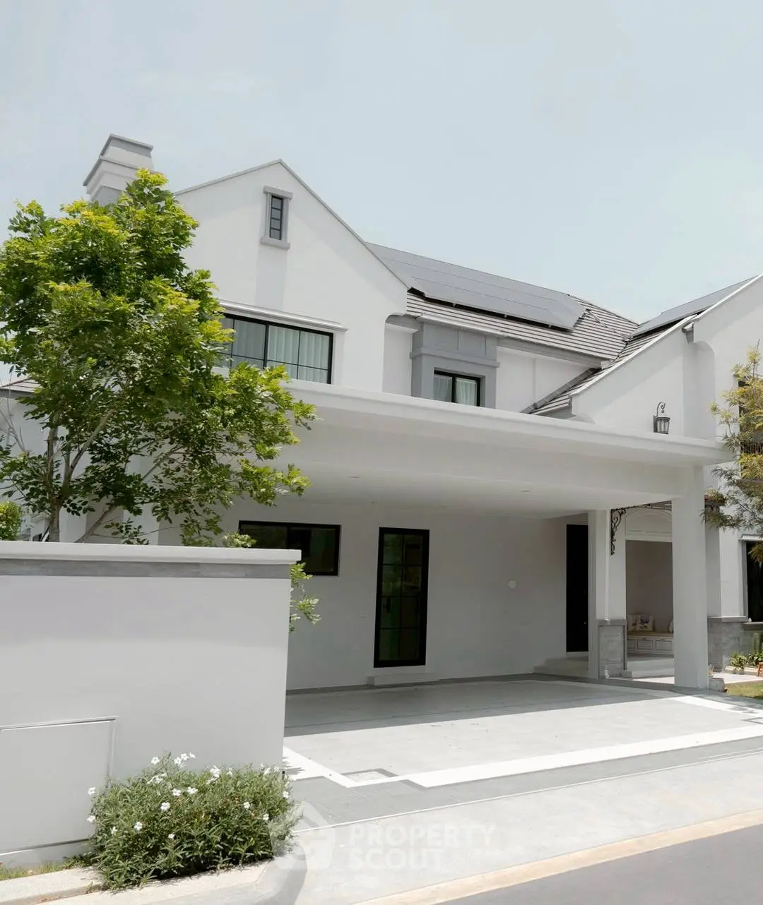 Elegant modern house exterior with clean lines and lush greenery, showcasing contemporary architectural design.