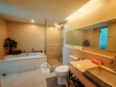 Luxurious modern bathroom with bathtub and glass shower enclosure