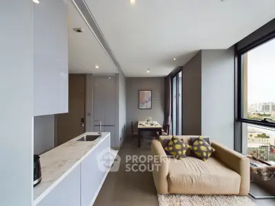 Modern living room with open kitchen and city view, featuring stylish decor and ample natural light.