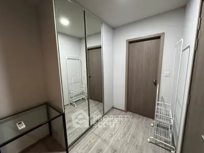 Modern storage room with mirrored closet and sleek flooring