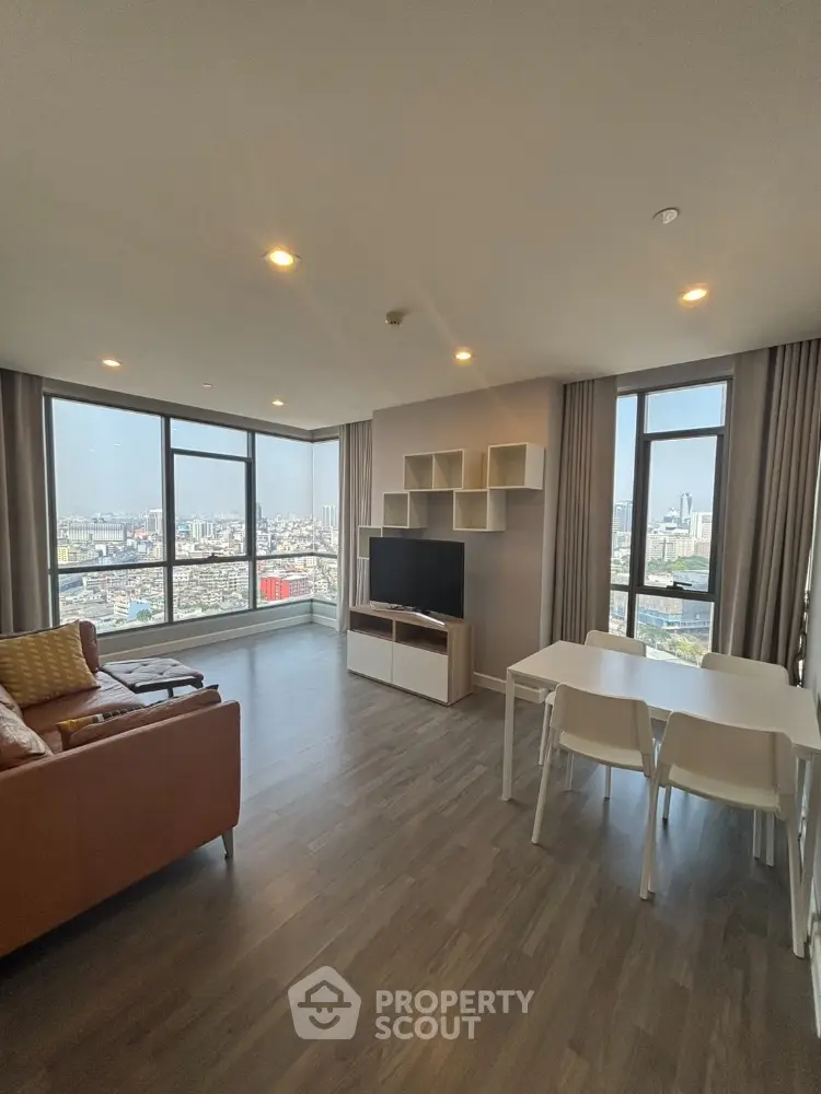 Modern living room with panoramic city views and stylish furnishings