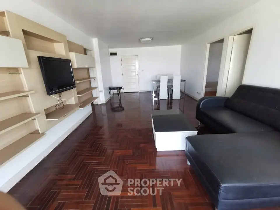 Spacious living room with modern furniture and wooden flooring