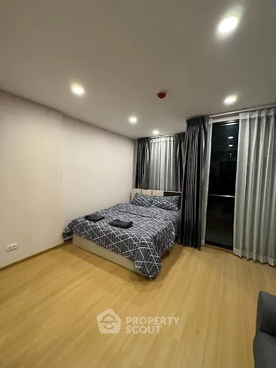 Modern bedroom with cozy lighting and stylish decor in a contemporary apartment.