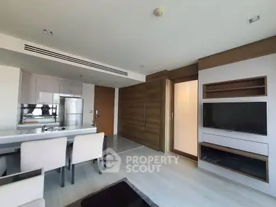 Modern living room with open kitchen and sleek wooden accents