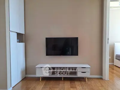 Modern living room with mounted TV and sleek wooden flooring