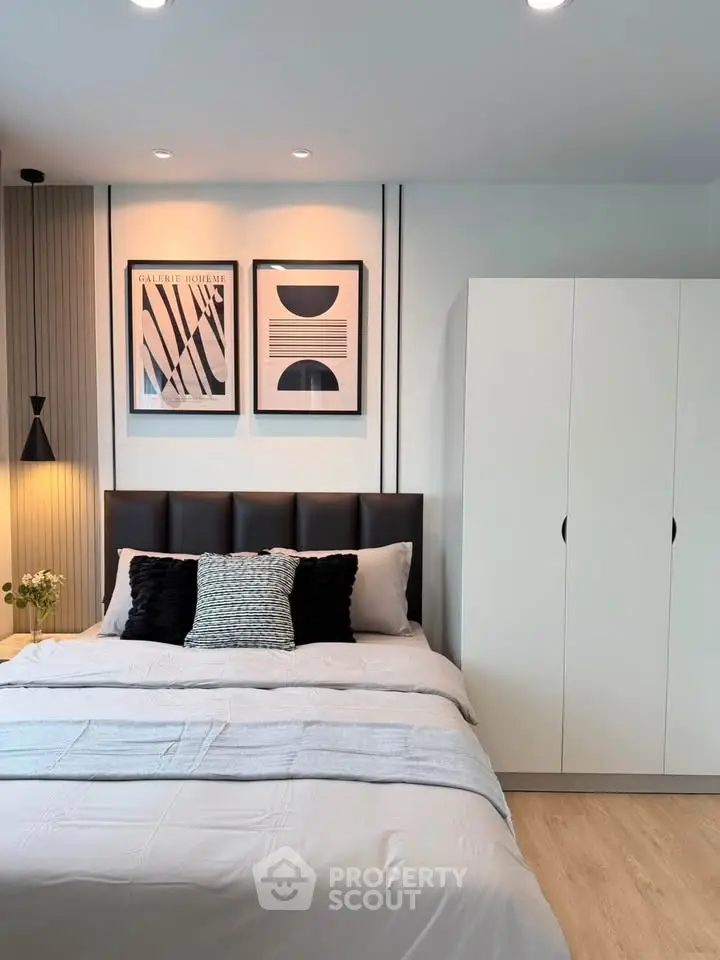 Modern bedroom with stylish decor and cozy bedding in a contemporary apartment.