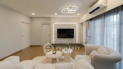 Elegant living room with modern decor, featuring a wall-mounted TV and stylish furniture.