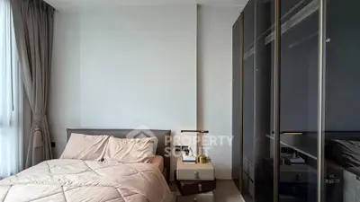 Modern bedroom with sleek wardrobe and cozy bedding in a stylish apartment.