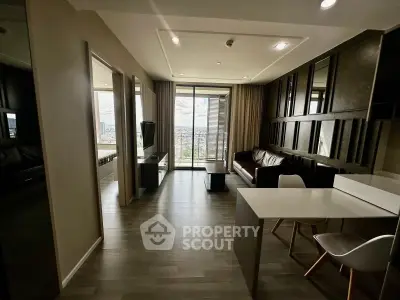 Modern living room with sleek furniture and large windows offering a stunning city view.