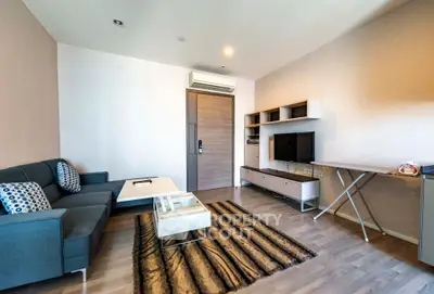 Modern living room with sleek furniture and stylish decor, featuring a comfortable sofa and entertainment unit.