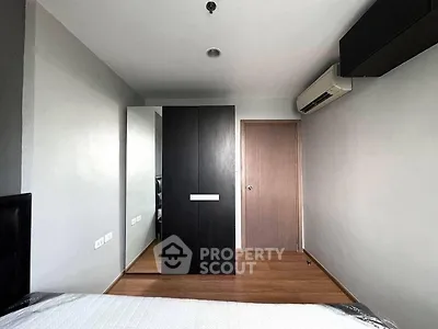 Modern bedroom with sleek wardrobe and air conditioning unit