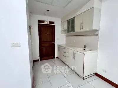 Modern kitchen with sleek cabinetry and minimalist design in a contemporary apartment.