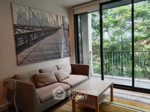 Charming living room with cozy sofa and balcony view, perfect for relaxation.