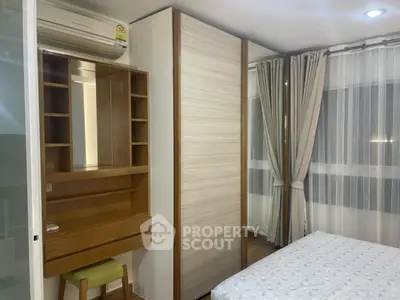 Modern bedroom with built-in wardrobe and vanity desk, featuring large windows with elegant curtains.
