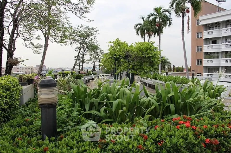 Lush rooftop garden with city views and tropical plants