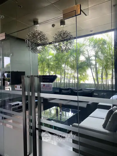 Luxurious karaoke room with modern decor and lush greenery view