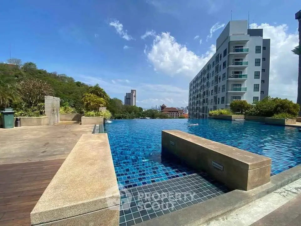Stunning infinity pool with cityscape view in modern residential complex