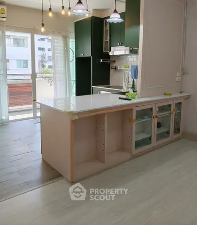 Modern kitchen with open layout and stylish lighting in a bright apartment.