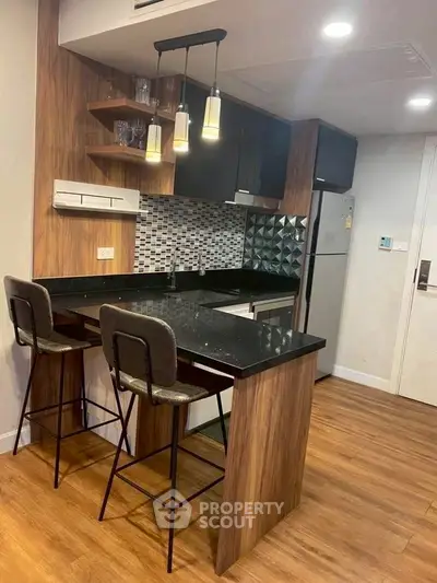 Modern kitchen with stylish bar seating and sleek wooden finishes