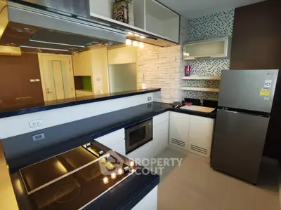 Modern kitchen with sleek design, featuring built-in appliances and stylish countertops.
