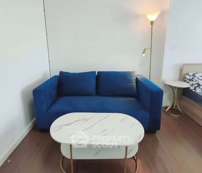 Modern living room with blue sofa and stylish marble coffee table