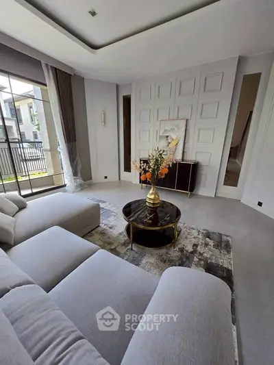 Luxurious modern living room with elegant decor and large windows for natural light.