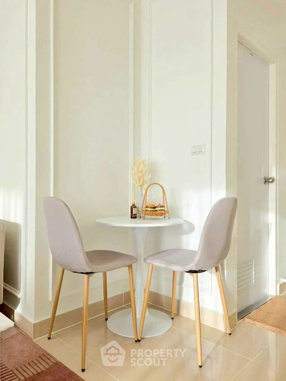 Cozy corner with elegant chairs and round table in a bright, modern interior space.