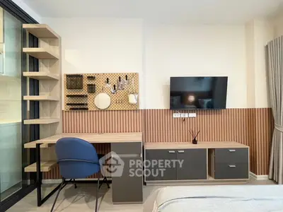 Modern study area with stylish desk, shelving, and wall-mounted TV in a cozy apartment.