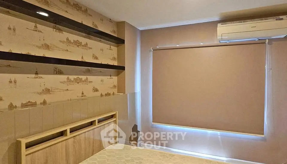 Cozy bedroom with air conditioning and stylish wallpaper, perfect for relaxation and comfort.