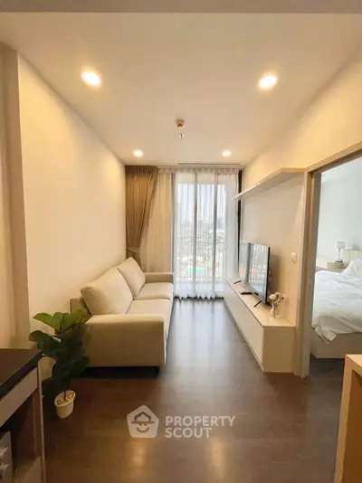 Modern living room with cozy sofa and large window offering city view