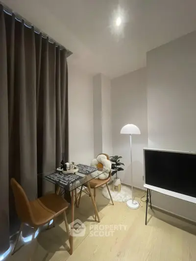 Modern dining area with stylish furniture and ambient lighting in a cozy apartment.