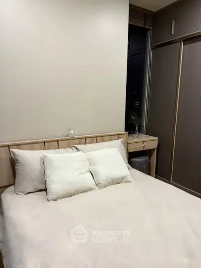 Cozy bedroom with modern design and ample storage space, perfect for urban living.