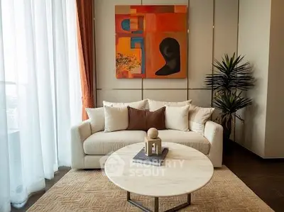 Elegant living room with modern art and cozy sofa, perfect for relaxation.