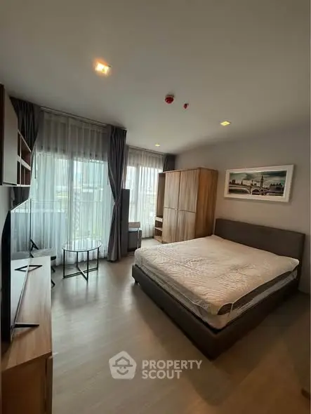 Spacious modern bedroom with large windows and stylish furniture