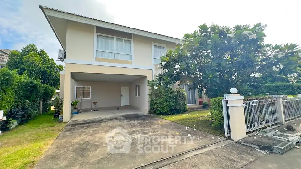 Charming two-story house with lush garden and spacious driveway in serene neighborhood.